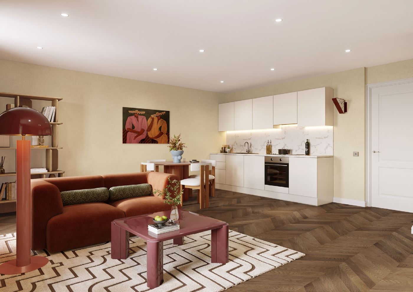 Open-plan living room and kitchen with herringbone flooring and a terracotta sofa