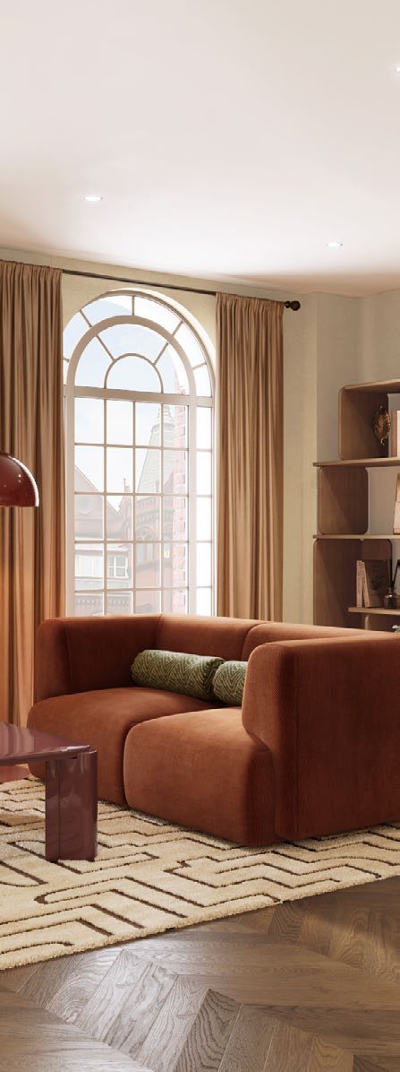 Original arched sash window beside a terracotta sofa